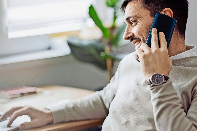 1363697779 Home Office: An Anonymous Man Using a Laptop for Online Trading While Working From Home