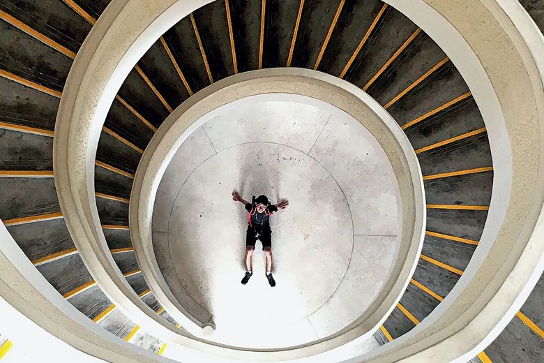 2164923582 High Angle View Of Man At Bottom Of Spiral Staircase