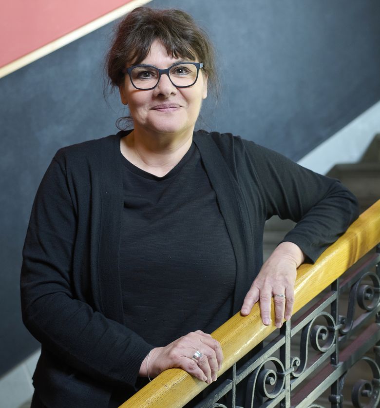 Ursula Bähler, Professorin für französische Literatur, lehnt an einem Treppengeländer.